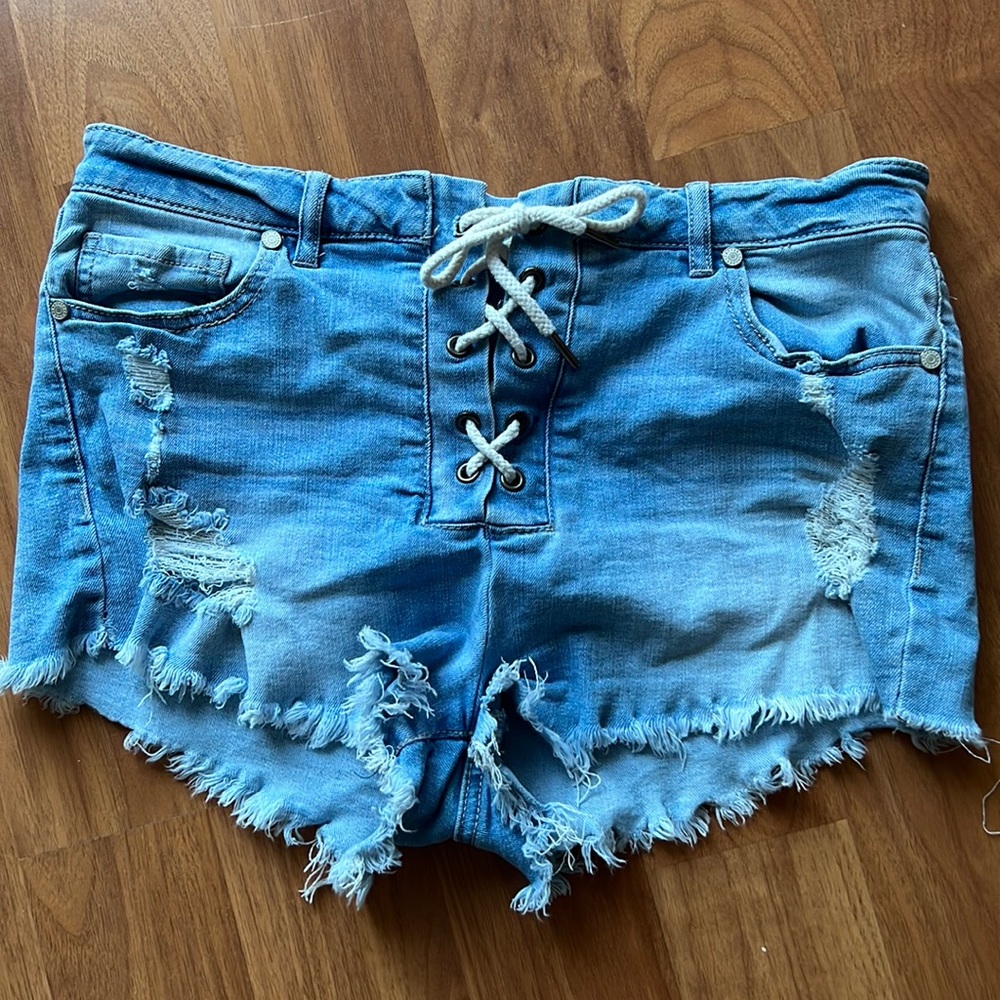 Refuge cut off shorts. Light blue denim with criss cross stitch up detail.
